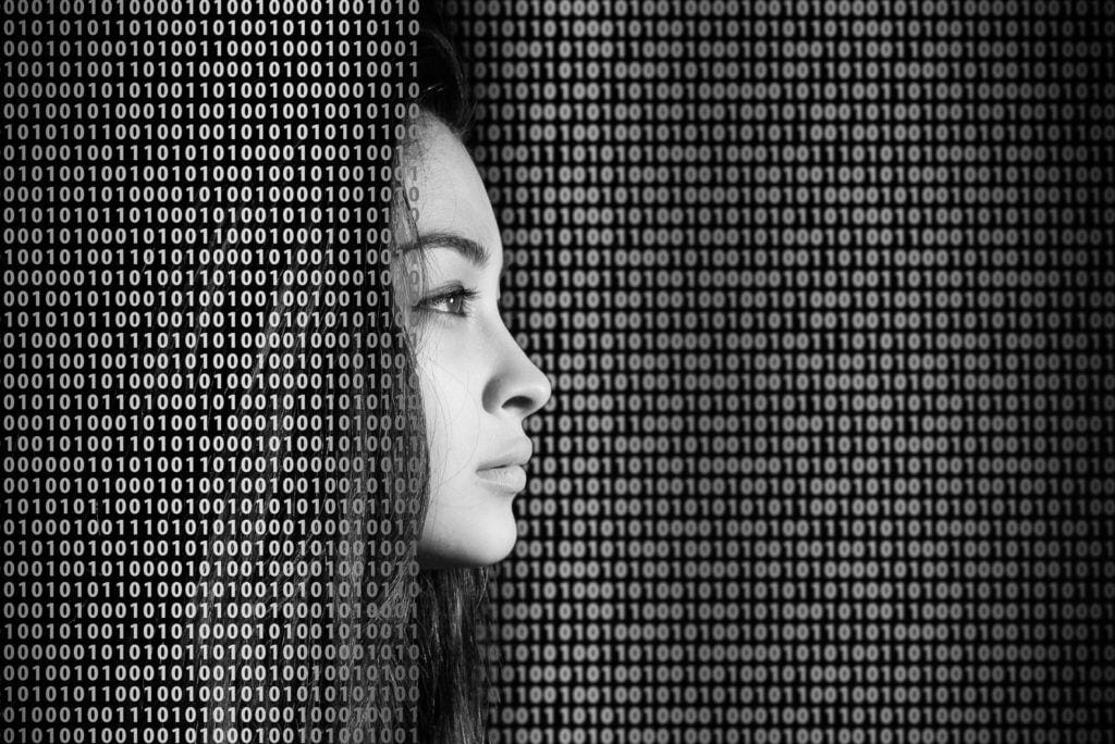woman face among the binary 0s and 1s - de-identified laboratory data