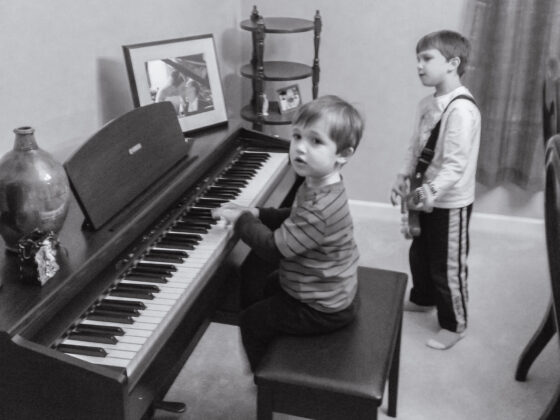 My mom teaching 2 of my sons on the piano